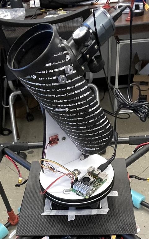 Newtonian telescope tube mounted on the drone payload plate with its control electronics