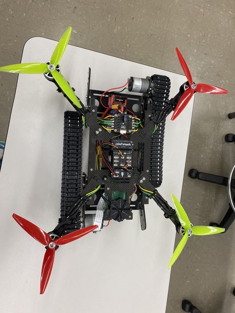 Carbon-fiber hybrid vehicle with tank treads, four rotor arms and a Pixhawk flight controller