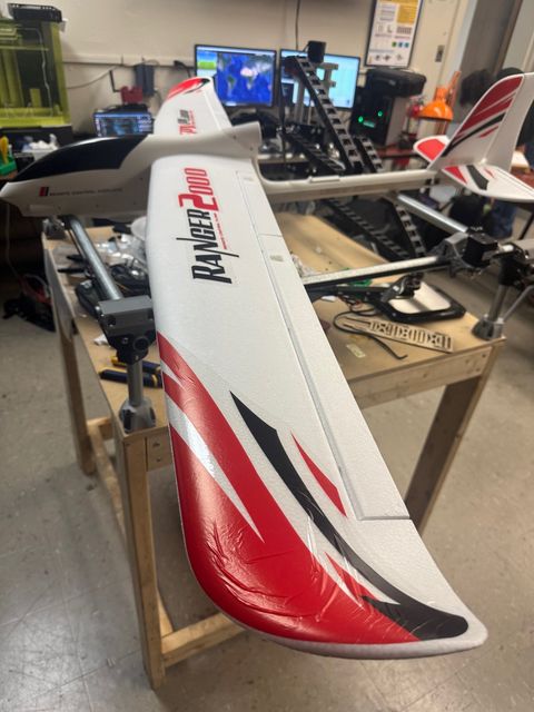 Fixed-wing solar UAV airframe on its assembly stand in the lab