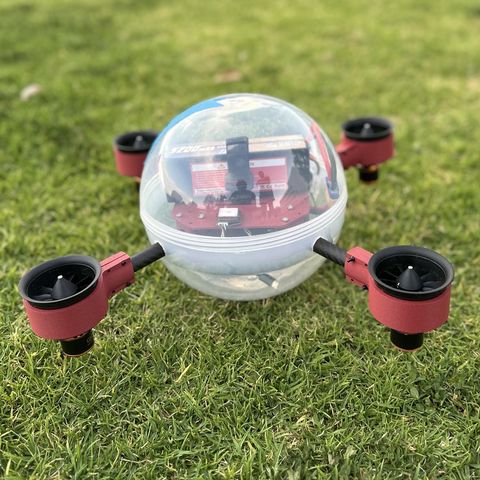 AQUAD on grass, its pressure dome and red EDF thrusters visible